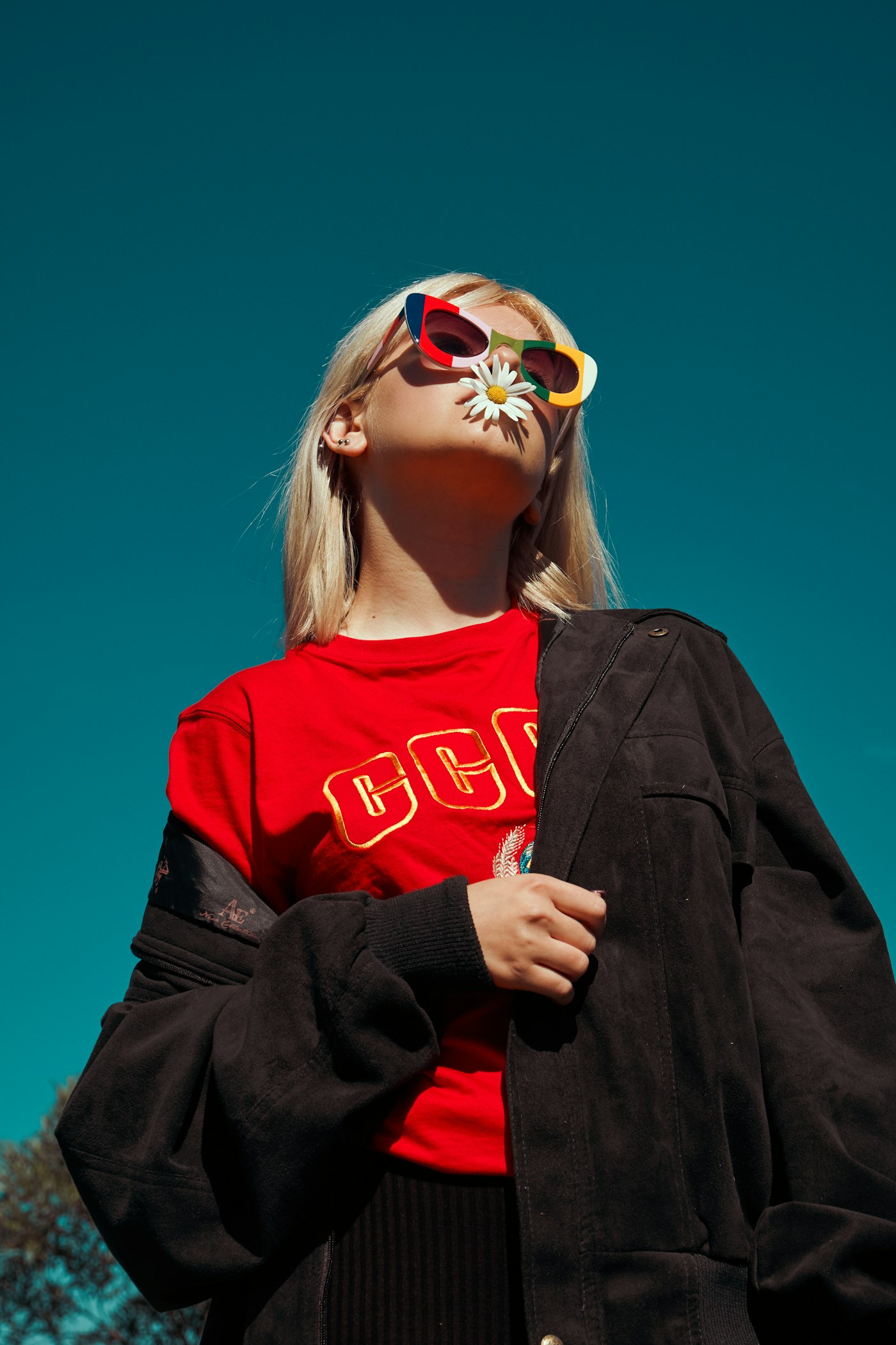 Model in a red graphic tee and oversized jacket